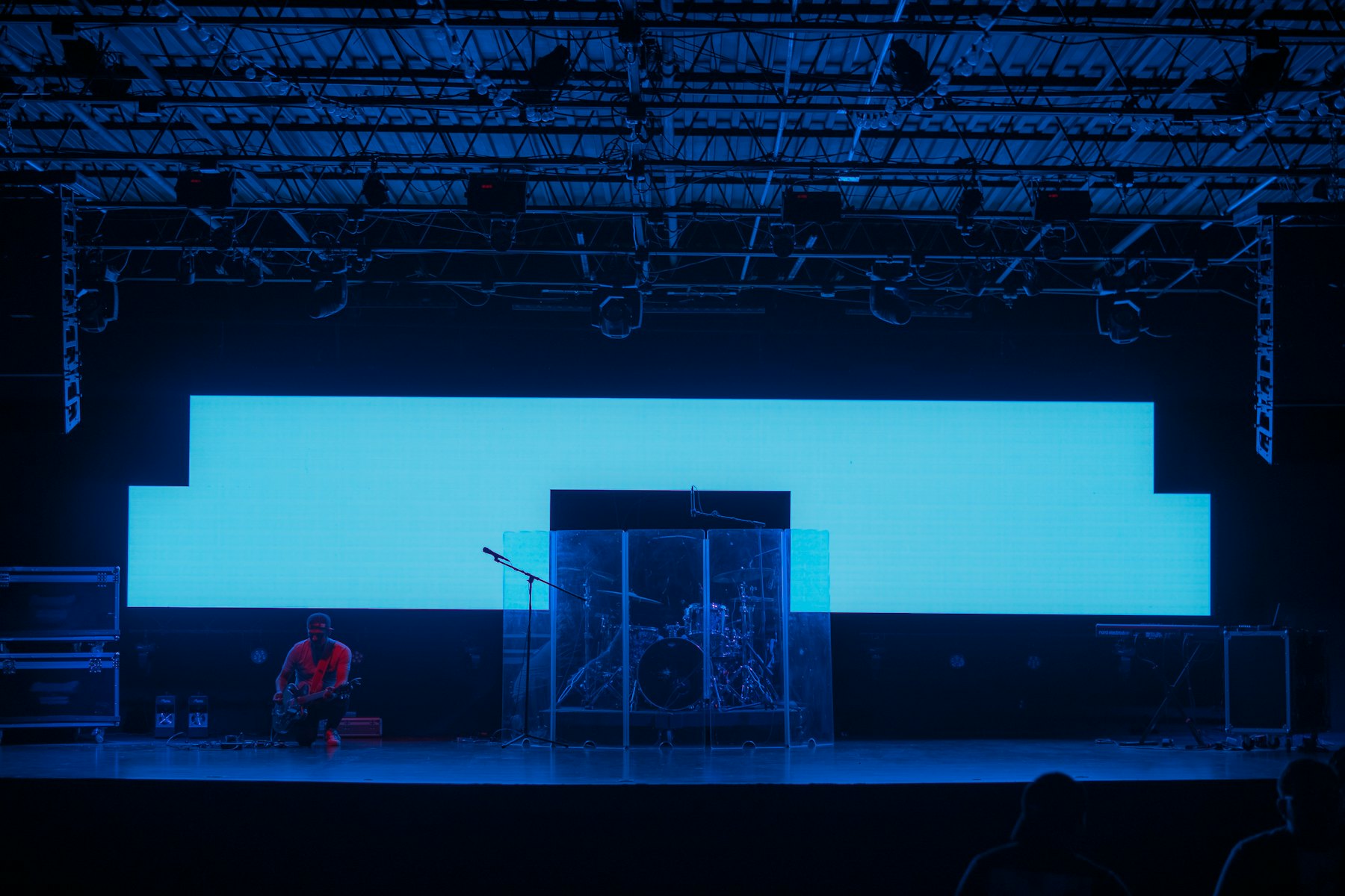 Technician setting up in front of a large LED wall on a lit stage